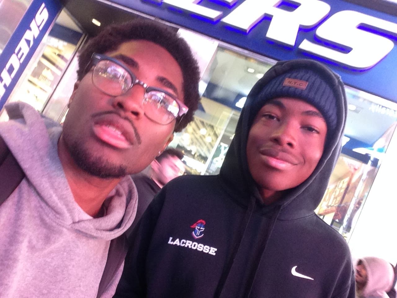 Selfie with a friend outside a store in Times Square