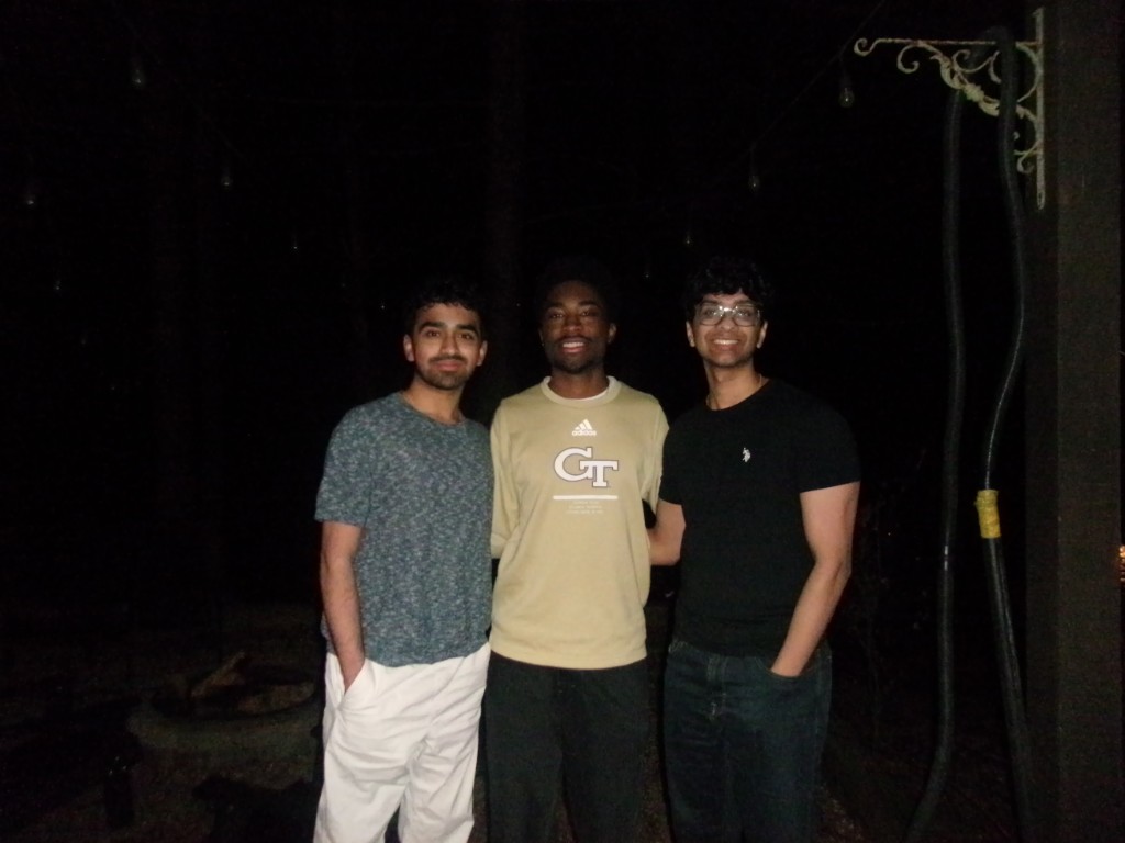 Three friends together outdoors at night