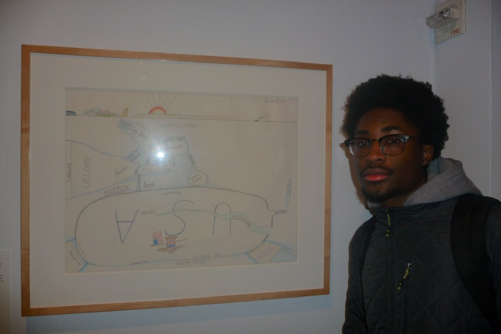 Standing next to a framed map artwork in a gallery